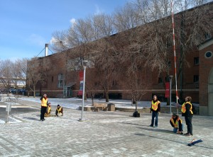 On January 16 at approximately solar noon, the students went outside in front of campus with a 24-foot pole—which they made by connecting six four-foot range poles. They held the pole vertically and used a plumb bob to confirm it was vertical. They then used a 100-foot tape measure to determine the length of the shadow cast by the range pole. 