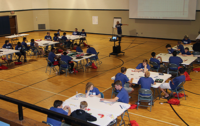 STEM camp students working on a Lego manufacturing simulation 