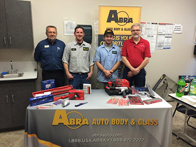 Anthony smiling after receiving tools from ABRA representatives 