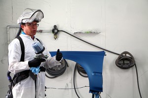 A photo of the waterborne paint expert talking at the event inside Dunwoody's waterborne spray paint booth 