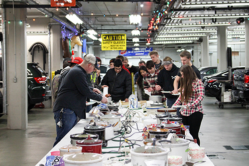 Dunwoody Automotive students loading up their lunch plates at the annual holiday potluck event in the Warren building