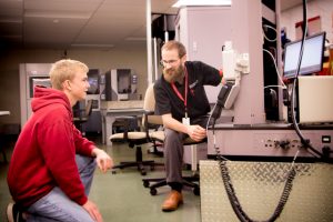 Mechanical Engineering Instructor Jonathan Aurand works with a student in the Metrology Lab. 