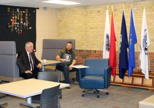 President Rich Wagner speaks to a veteran student during the Grand Opening of the new Center