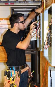 Dunwoody Electrical Construction & Maintenance student practices residential wiring inside Dunwoody's onsite house