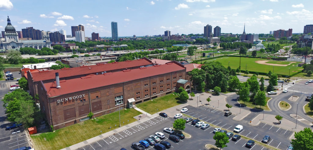 The Dunwoody campus main building from the west with the Minneapolis skyline in the background