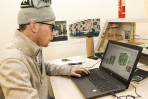 Student Tanner Konen showing a 3D rendering of some of his design