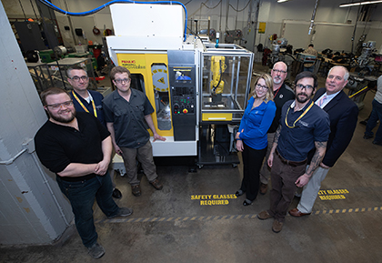 Dunwoody students, faculty, and administrators standing in front of the Fanuc MTEC alongside representatives from Graco