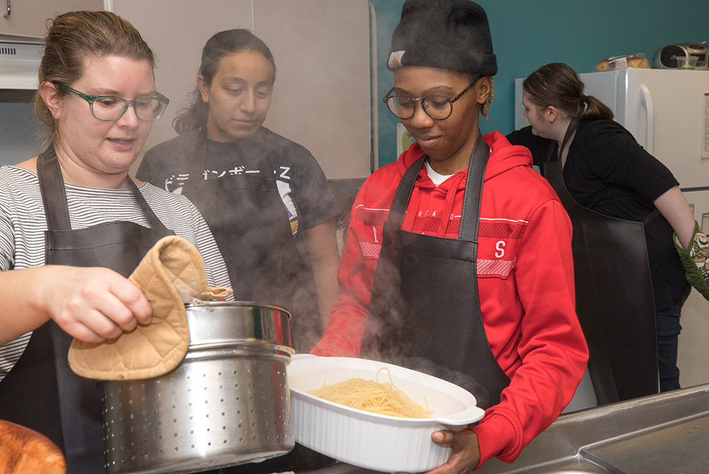 Maggie Whitman, associate director of Women's Initiatives, left, Liz Rivas, Charity Stevson, and Samantha Taift volunteer at Jeremiah Program.