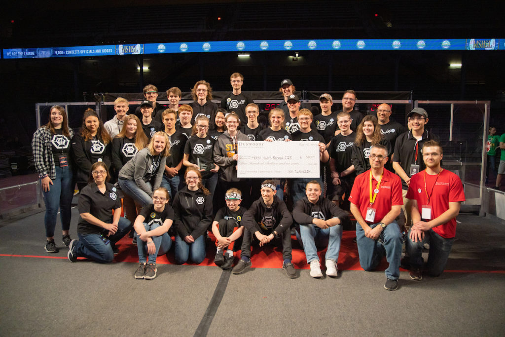 Photo of the Becker CIS team holding a big check