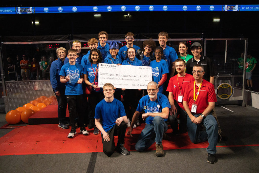 Photo of the Eagan High School team with a giant check