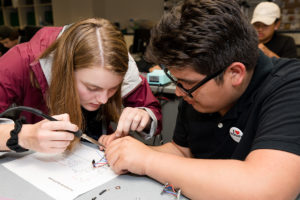 Mia Troska solders wires for a flashlight she made during her YCAP experience.