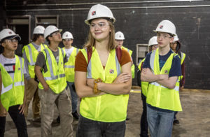 Mia Troska, front, tours a school being renovated by Kraus-Anderson while attending the Youth Careers Awareness Program summer camp. She is considering a degree in either Construction Management or Electrical Construction Design & Management. 