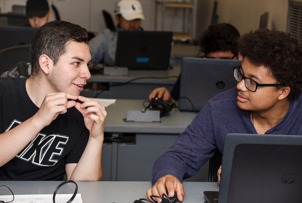 Mark Velez talks with another participant in the (Youth Career Awareness Program. 