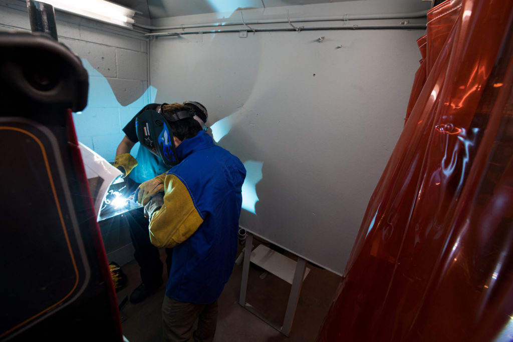 Zhiwei Blaubach in the welding booth during a YCAP session. 