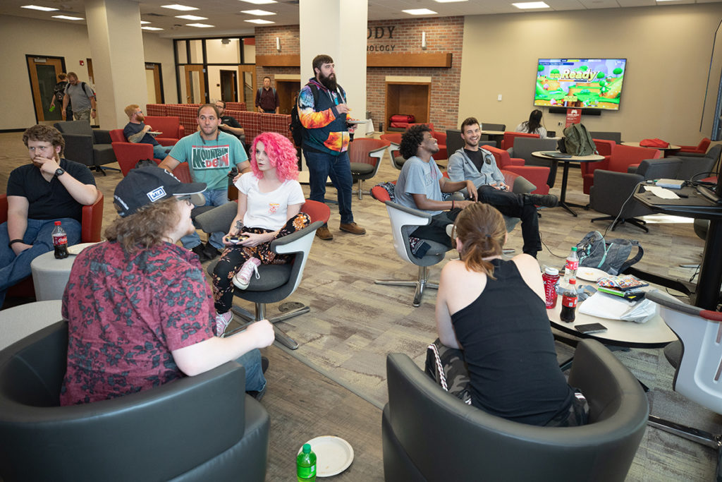 Students gather in the Fireside lounge to play video games during Student Affairs Game Night.