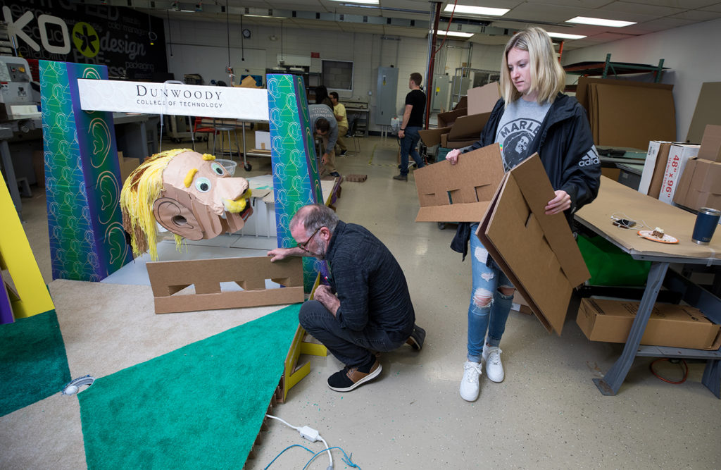 Students in the Advanced Structural Design class build a mini golf hole out of corrugated material for an entry at the Design Camp.