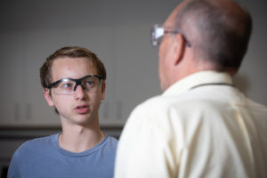 Benjamin Larsen talks with School of Engineering Dean Bill Hudson in a Mechanical Engineering lab.