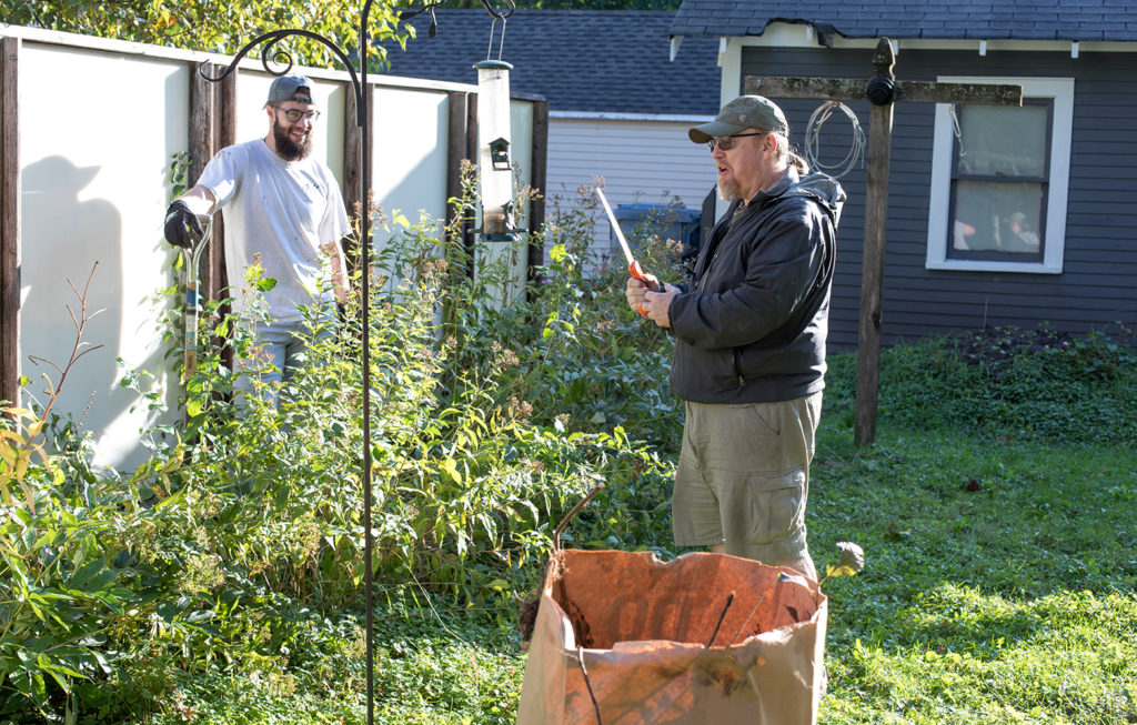 Industrial Engineering student Nick Mitchell talks with homeowner Tim Fairbanks.