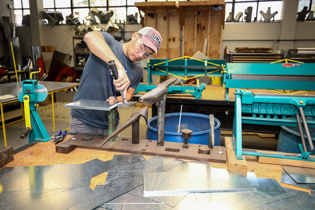 Tommy Dao in the HVAC lab fabricating a toolbox he designed to hold tools he designed and fabricated.