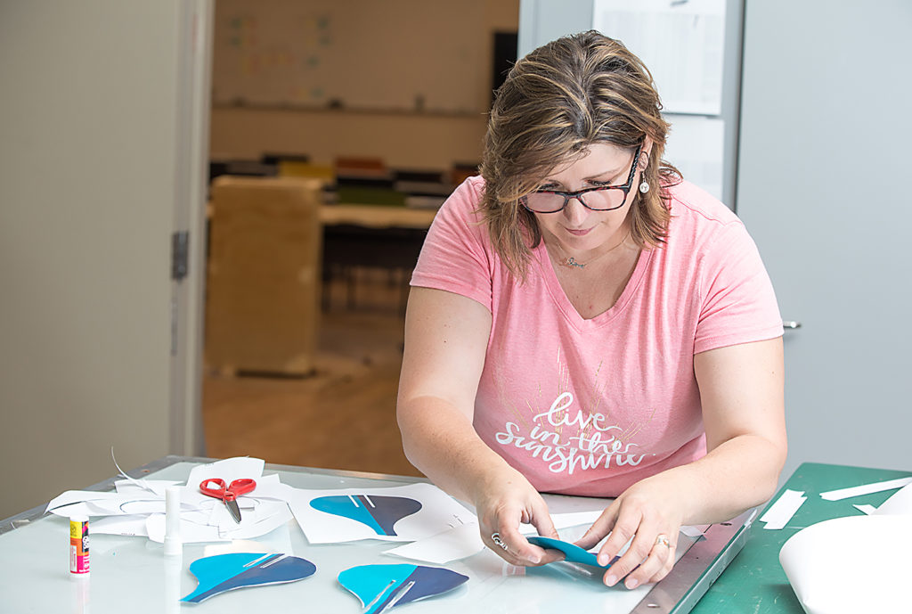 Michele Stenzel works on a design for a project that will be on display at the Minnesota State Fair.