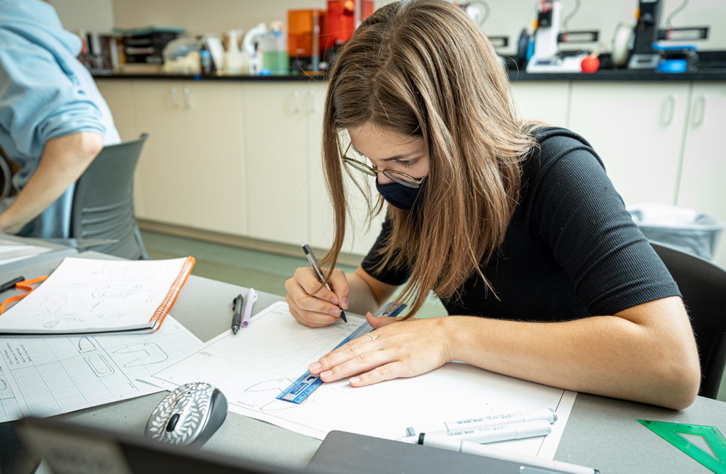 Bridgette Dalldorf sketches designs for a golf putter in lab