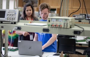 School of Engineering Academic Director Noureen Sajid works with a student in an engineering lab. 