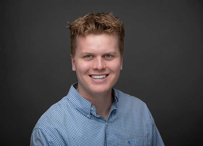 portrait of Nick Metzler wearing a blue shirt.