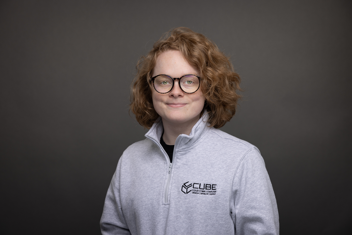 portrait of Amelia Marrone wearing gray shirt with CUBE logo