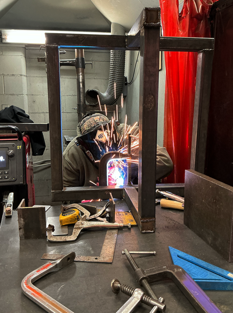 Randee Wrobel, recent graduate of  Welding & Metal Fabrication at Dunwoody College, working on a project in the welding shop. 