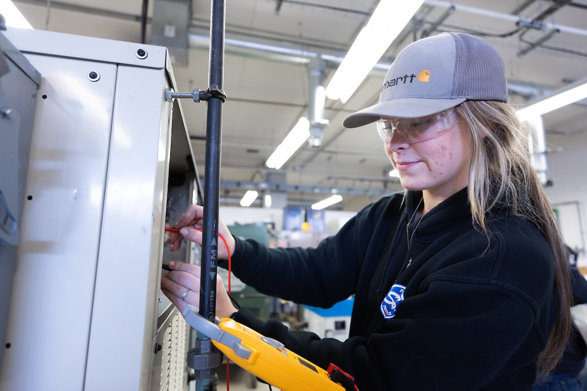 A student in an HVAC lab learning to monitor and test HVAC systems.