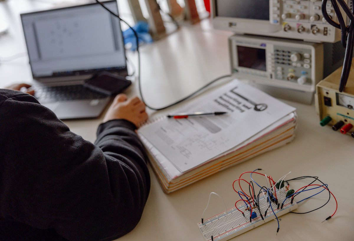 An electrical engineering student in the electronics lab.