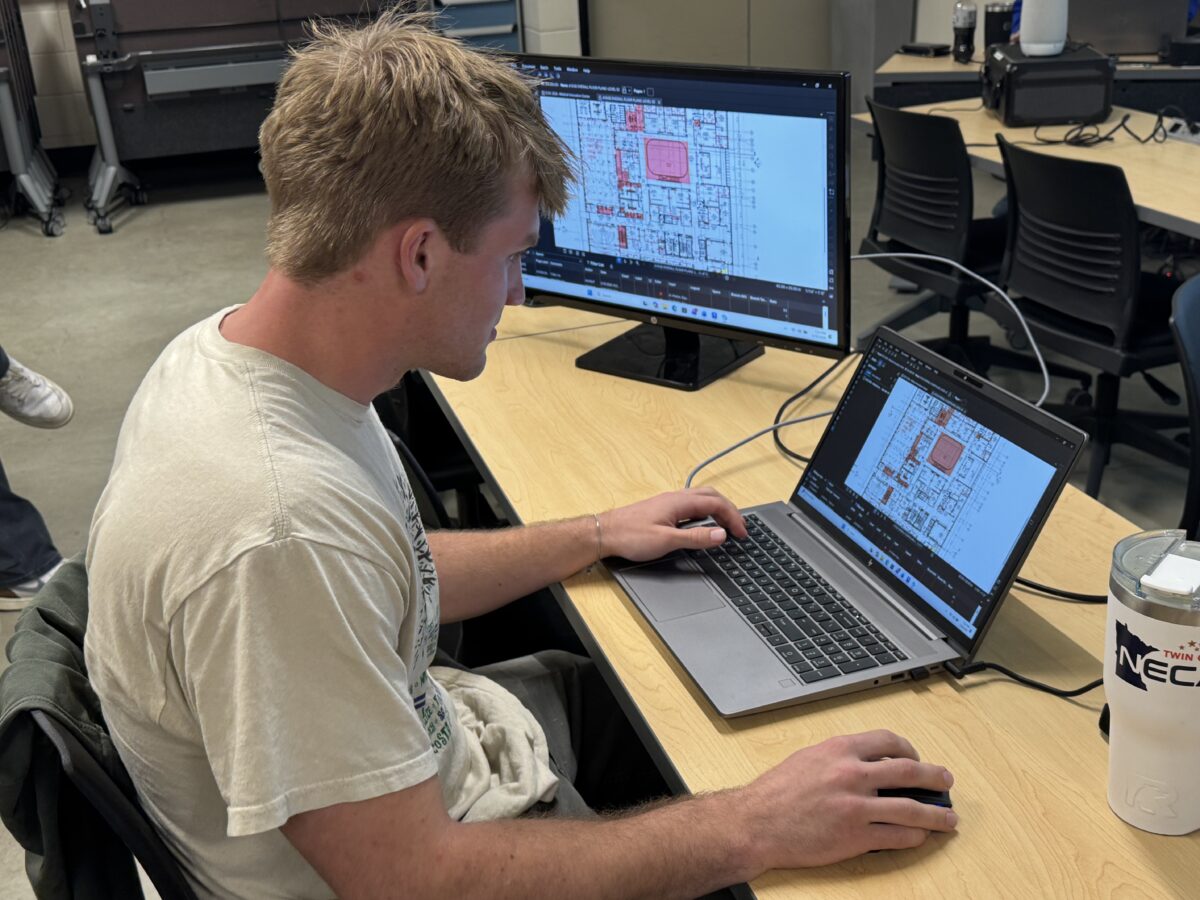An Electrical Construction Design & Management student works on a component of the ECIC Competition.