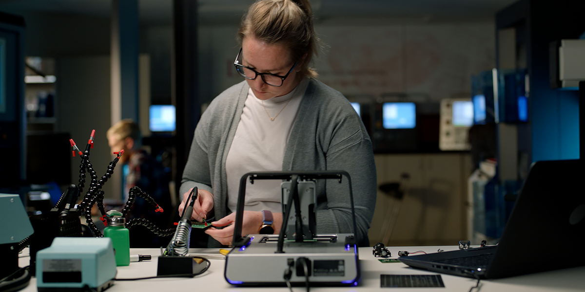 A student in the electrical engineering degree program works in the Metrology Lab as part of her electrical engineer courses.