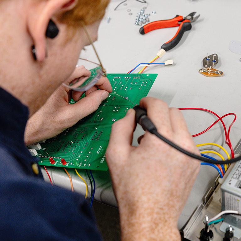 person holding a circuit board