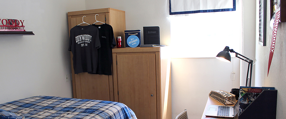 An alternate view of the bedroom showing a wardrobe and large cupboard