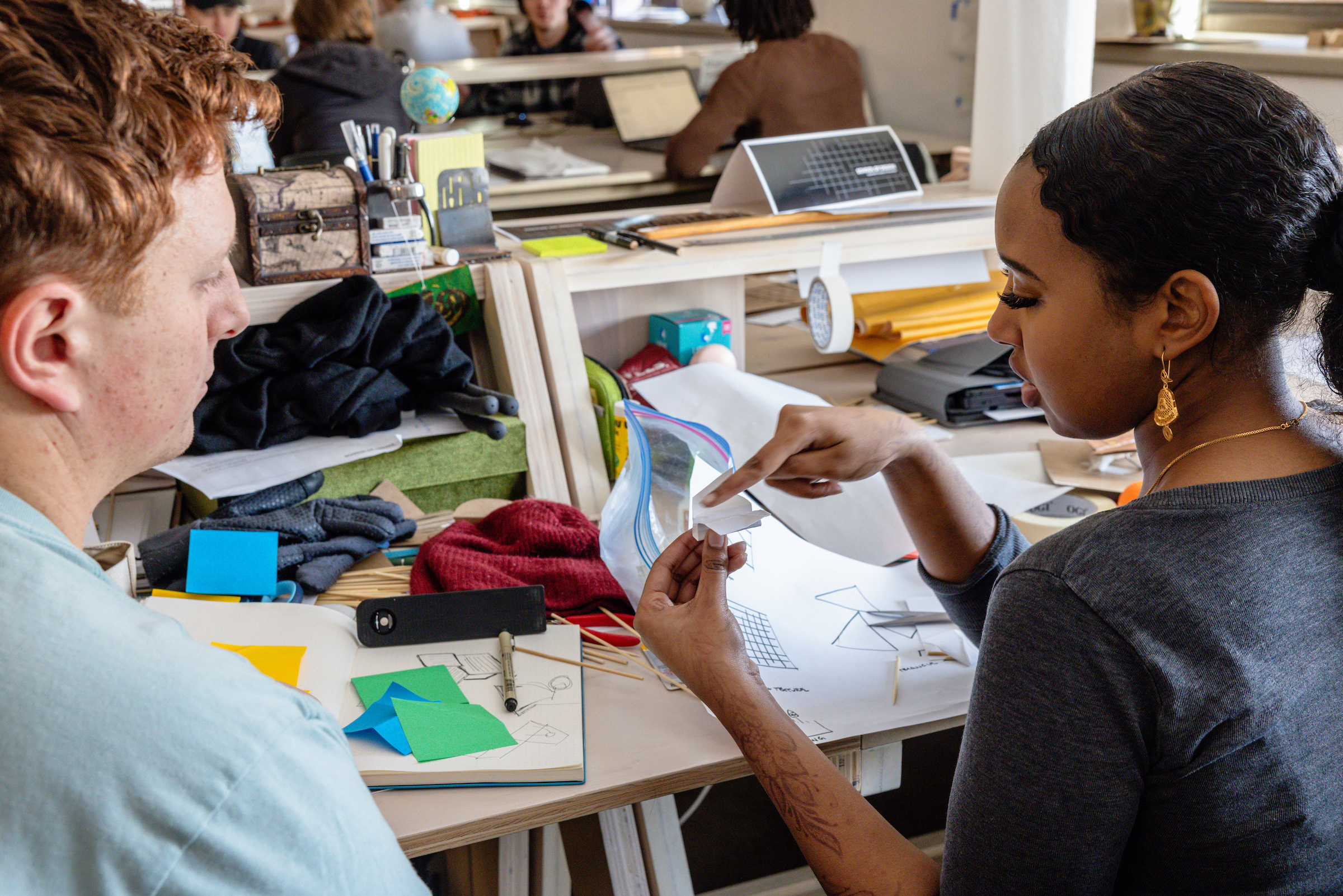 Students working together in a School of Design studio space.