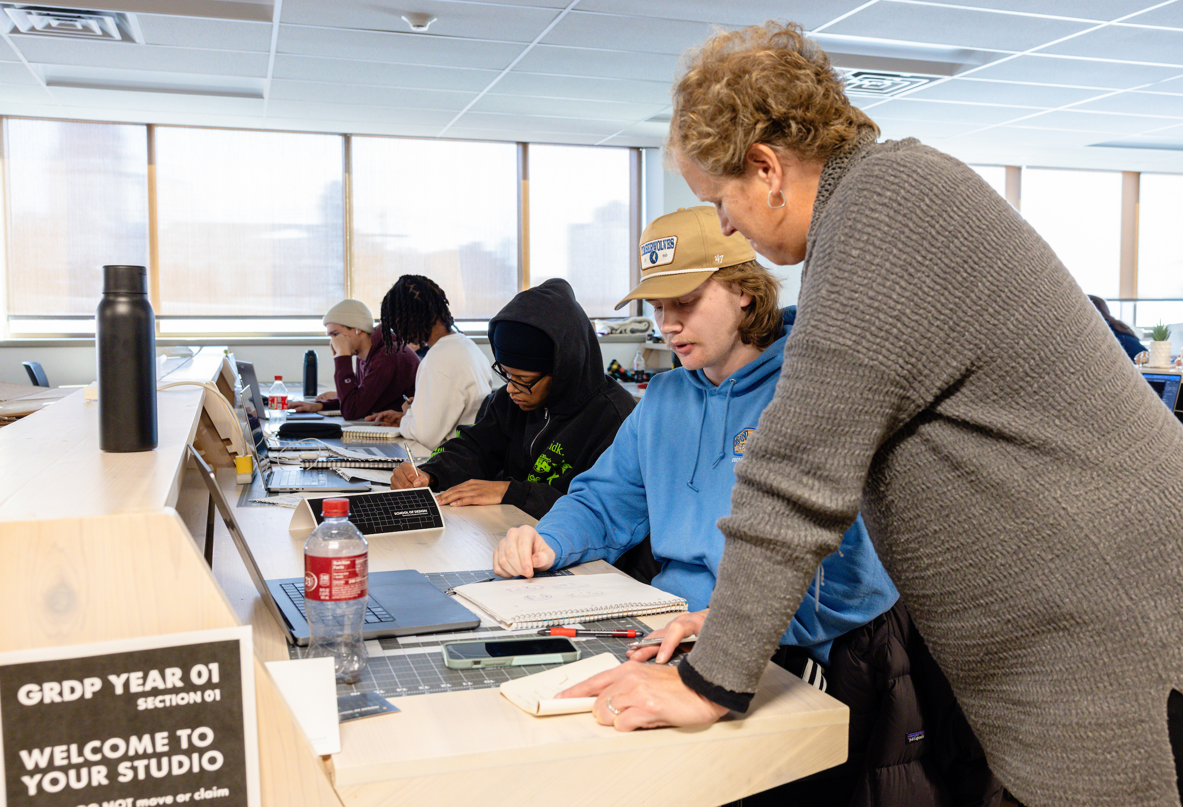 Graphic Design students working in a Design Studio with faculty.