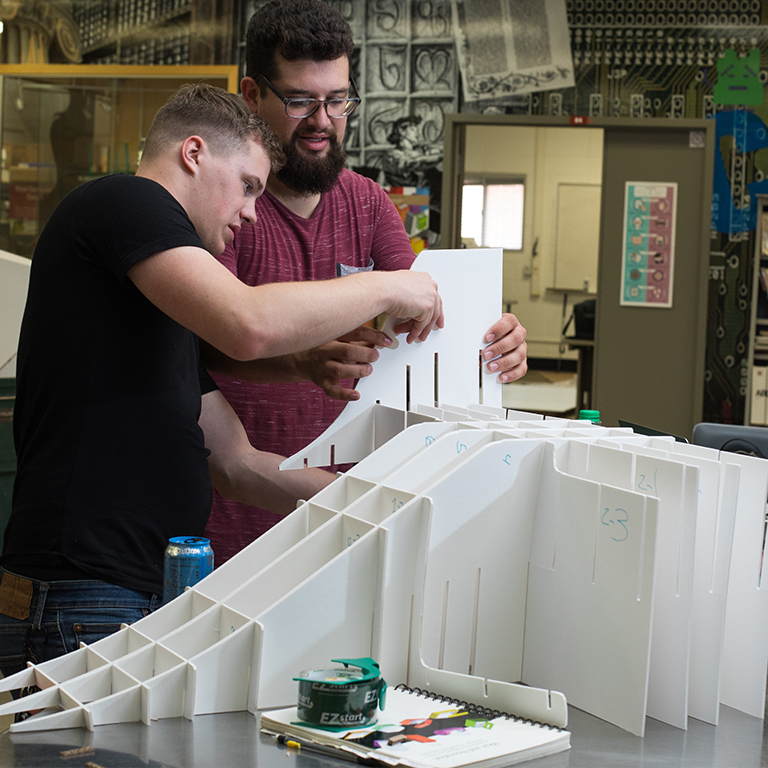 Design students working on a corrugated cardboard display