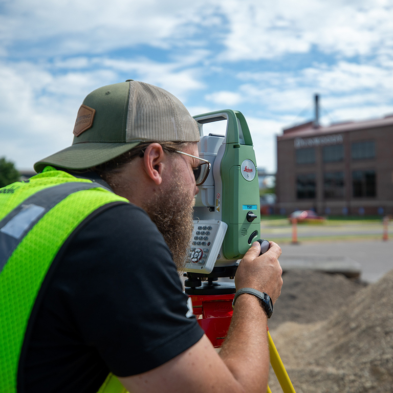 A student using a piece of surveying equipment
